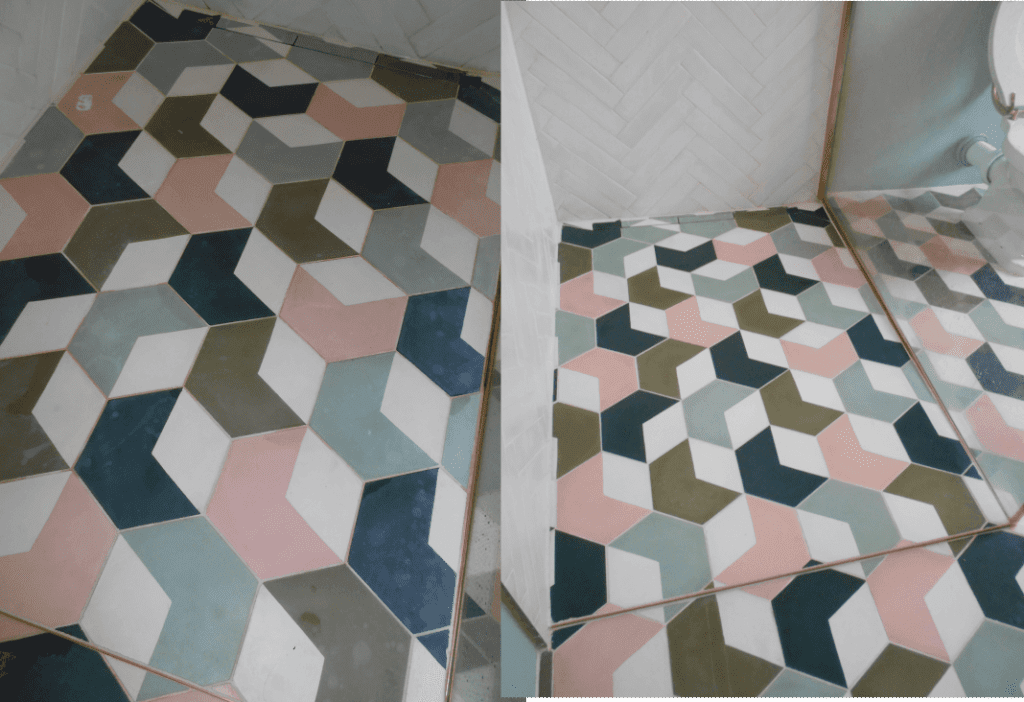 colourful cement encaustic tiles on a wetroom floor that have become bleached and stained