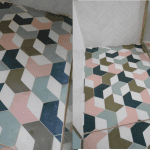 colourful cement encaustic tiles on a wetroom floor that have become bleached and stained