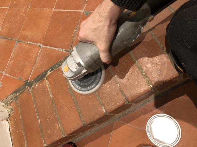 buffing the bees wax into the quarry tiles