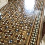 A large Victorian tiled hallway that has been cleaned and waxed in Radlett. Hallway is double the width of usual Victorian hallway and features a star like design with Victorian encaustic tiles