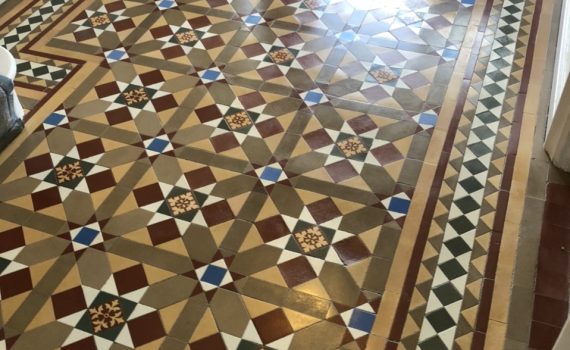 A large Victorian tiled hallway that has been cleaned and waxed in Radlett. Hallway is double the width of usual Victorian hallway and features a star like design with Victorian encaustic tiles