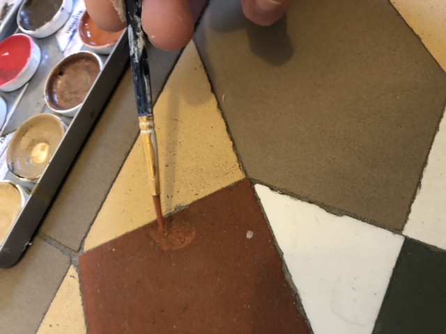 filling and painting in a chip on a Victorian tiles