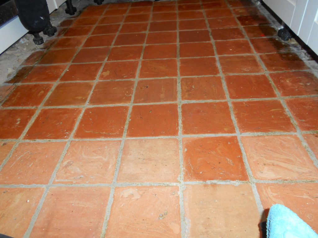 quarry tiles carefully being waxed