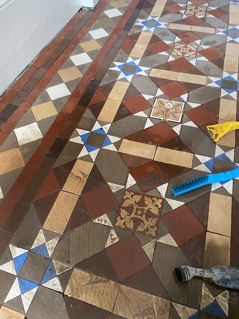 during the cleaning stage with Victorian hallway tiles. Black sludge comes out of tiles