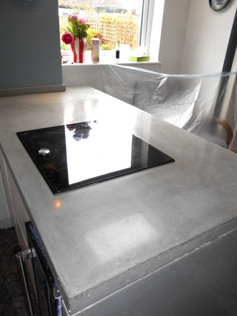 concrete work surface with cooker that has been completely resurfaced, cleaned and polished.