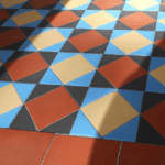 very bright and colorful Victorian tiles in a hallway in North London that we deep cleaned and sealed. The tiles are bright yellow, red, blue and black