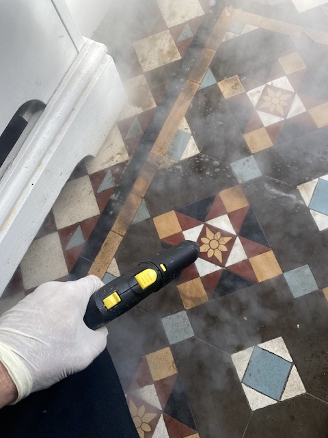 Victorian geometric tiles being steam cleaned