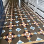 Victorian geometric hallway restoration Chiswick. design features a half octagon tile in coffee color. There are blue , yellow and black Victorian tiles