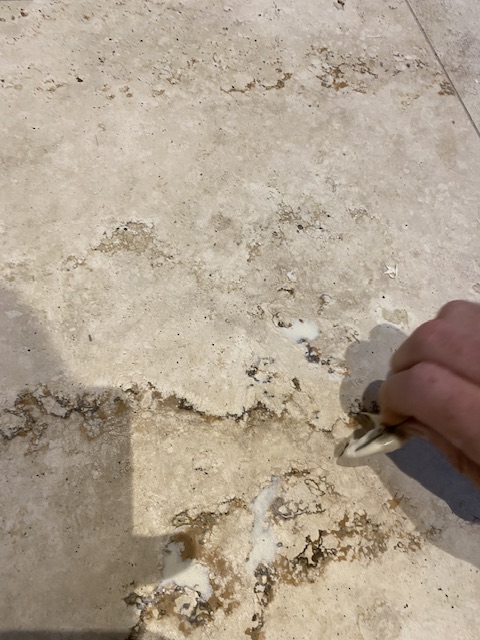 travertine stone tiles being resin filled before polishing