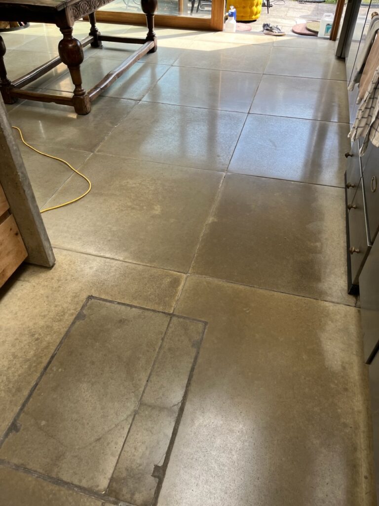 Concrete floor tiles on kitchen polished