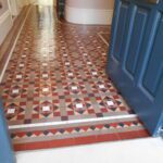 stunning Victorian tiled geometric hallway deep cleaned in Hertfordshire. Yorkstone front step to house with red,yellow, coffee, black and white geometric tiles