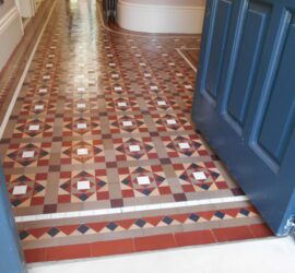 stunning Victorian tiled geometric hallway deep cleaned in Hertfordshire. Yorkstone front step to house with red,yellow, coffee, black and white geometric tiles