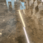 Dark grey limestone marble kitchen worktop that has had crystalliser polishing paste applied to create very high gloss in North London Crouch End