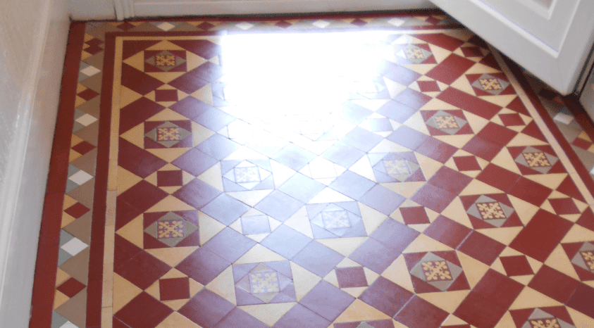 A pic showing a very shiny patch of a Victorian tiled hallway